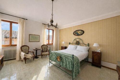 a bedroom with a bed and a table and chairs at La Terrazza sul Lago in Panicale