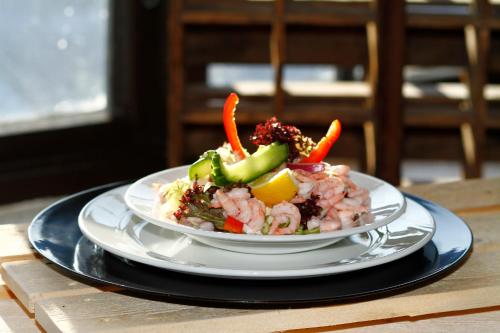 a plate of food with vegetables on a table at Grimstad Vertshus in Grimstad