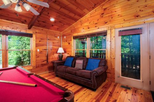a living room with a pool table in a cabin at Evening Star in Gatlinburg