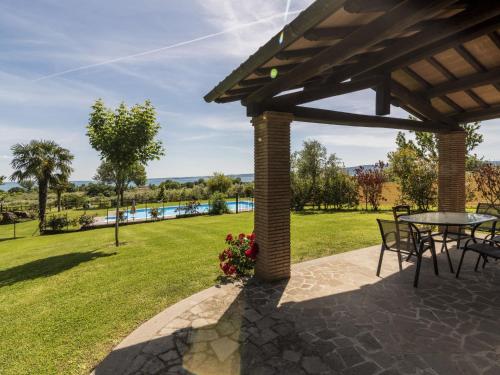 a patio with a table and chairs and a view of a park at Holiday Home Rosa Tea by Interhome in Bolsena