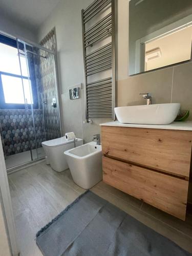 a bathroom with a tub and a sink and a tubermottermott at La Romantica in Riccione