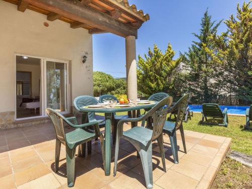 an outdoor dining area with a table and chairs at Holiday Home Bretos by Interhome in Fonts