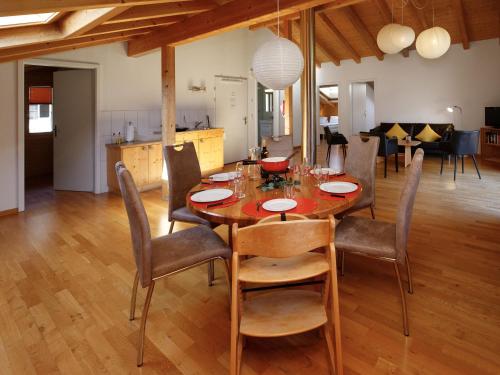a dining room with a wooden table and chairs at Apartment Chalet Almisgässli by Interhome in Grindelwald