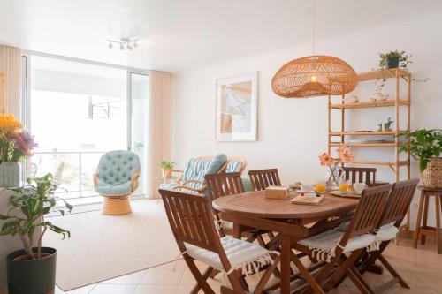 a dining room with a wooden table and chairs at Casa da Maresia - The Seaside Escape in Paul do Mar
