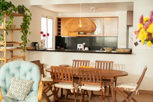 a dining room with a wooden table and chairs at Casa da Maresia - The Seaside Escape in Paul do Mar