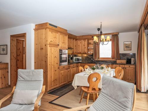 a kitchen with a table and chairs in a room at Apartment Chesa Dal Luf B5 by Interhome in Silvaplana