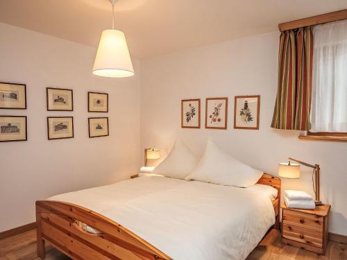 a bedroom with a bed and two lamps at Apartment Chesa Dal Luf B5 by Interhome in Silvaplana