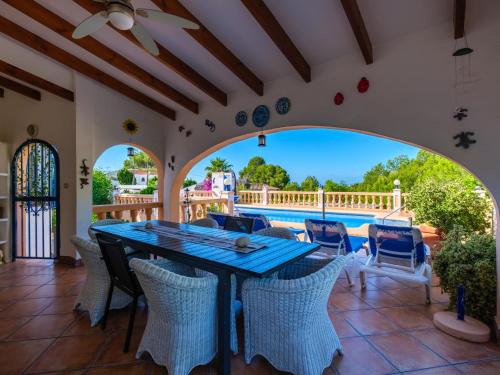 a patio with a table and chairs and a pool at Holiday Home Mirada al Sol by Interhome in Moraira