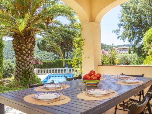 a blue table with a bowl of fruit on a patio at Villa Venecia by Interhome in Calonge