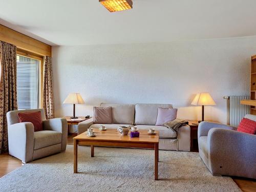 a living room with a couch and a coffee table at Apartment Victoria C 8 by Interhome in Crans-Montana