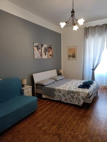 a bedroom with a bed and a couch and a window at Il Papavero Nero in Rome