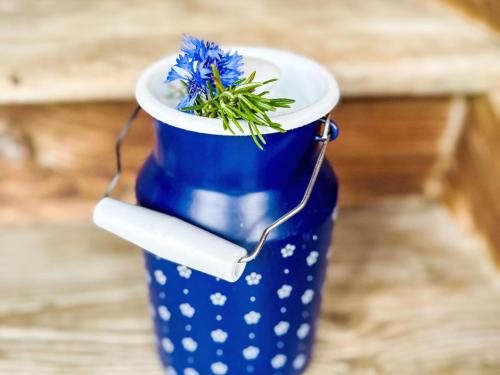 a blue and white cup with blue flowers in it at Apartment Scheftenau by Interhome in Wattwil