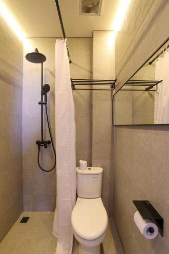 a bathroom with a toilet and a shower at The Dyastana Umalas in Kerobokan