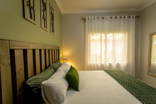 a bedroom with a bed and a window at Meerkat Manor Self-Catering & Accommodation Windhoek in Windhoek