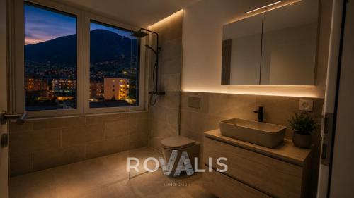 a bathroom with a sink and a window with a view at Private Panorama Spa Brig in Brig