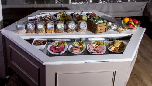 a buffet with many different types of food on it at Grimstad Vertshus in Grimstad
