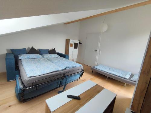 a room with a bed and a table in it at Am Weiher mit Terrasse in Hergensweiler