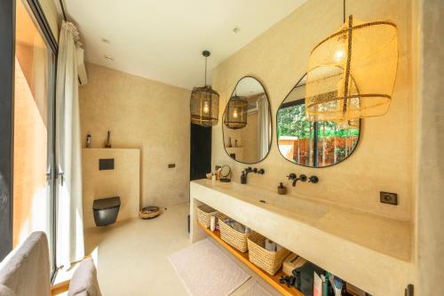 a bathroom with a sink and a mirror at Villa Madjha Ecolodge Marrakech in Marrakesh
