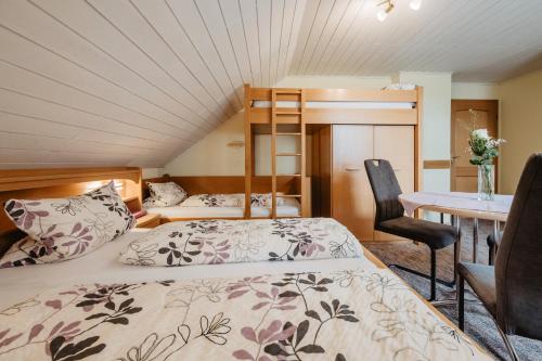 a bedroom with a bed and a desk and a bunk bed at Gäste-Haus Rösch in Wiesent
