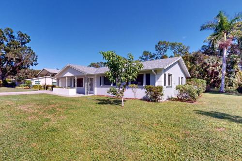 a white house with a yard at Serenity House - 1006 Ave 26th in Vero Beach