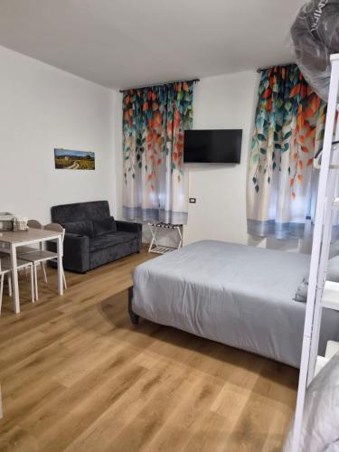 a bedroom with a bed and a living room at Malpensa Sleep & Go in Somma Lombardo