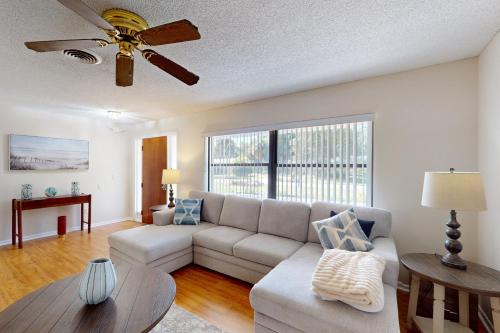 a living room with a couch and a ceiling fan at Serenity House - 1006 Ave 26th in Vero Beach