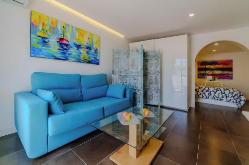 a living room with a blue couch and a table at Villa De Marcos in Arona