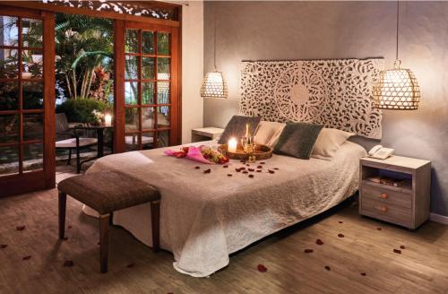 a bedroom with a large bed with candles on it at Lombok Hotel & SPA antes Hotel Casablanca in Guaduas
