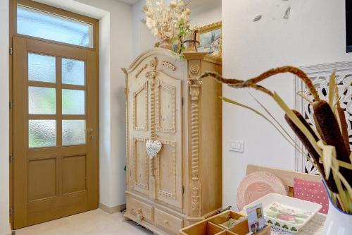 a large wooden cabinet in a hallway next to a door at Agriturismo Odorizzi in Tassullo