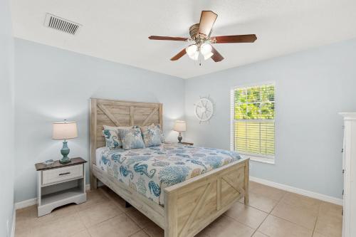 a bedroom with a bed and a ceiling fan at Paradise Vacay in Sebastian
