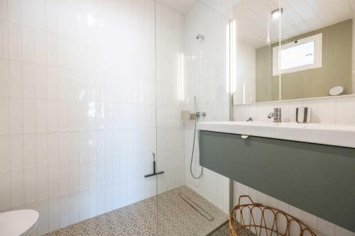 a bathroom with a sink and a toilet and a mirror at Rivara Rooftop By ALGARTUR in Cabanas de Tavira