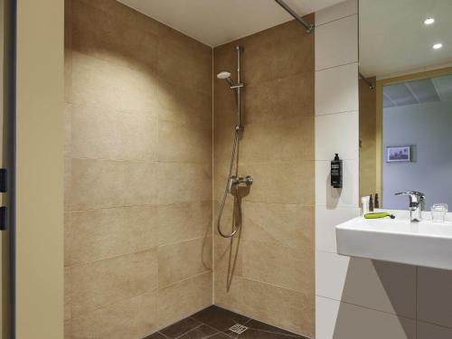 a bathroom with a shower and a sink at Ibis Budget Singen 24h geöffnet in Singen