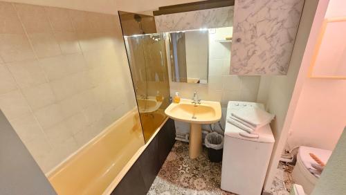 a bathroom with a sink and a toilet and a shower at Appart hôtel Roanne hyper centre ville in Roanne