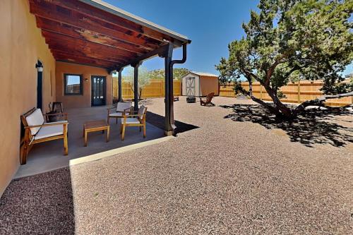 a patio of a house with chairs and a tree at Five Ravens in Santa Fe