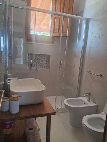 a bathroom with a shower and a sink and a toilet at Marina Serra in Marina Serra