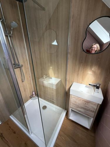 a person taking a picture of a bathroom with a shower at WHITEHILL STABLES in Kirknewton