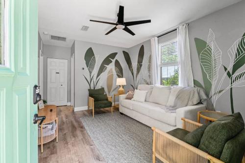 a living room with a couch and a ceiling fan at The Cedar Loft B - Team Joseph Ellen in St. Augustine