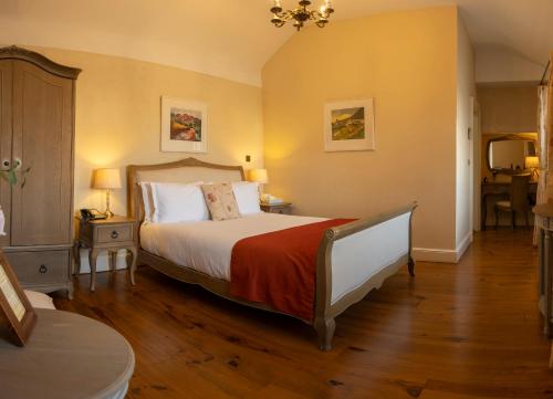 a bedroom with a large bed and a table at Corrib House Guest Accommodation in Galway