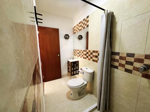 a bathroom with a toilet and a shower at The Rock House Eco in San Andrés
