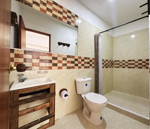 a bathroom with a toilet and a sink and a shower at The Rock House Eco in San Andrés