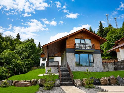 a house with a staircase in front of it at Crown Villa Bakuriani in Bakuriani