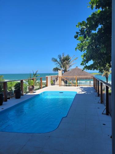 a swimming pool with the ocean in the background at Casa Cancun Hotel Boutique & Eventos in Penha