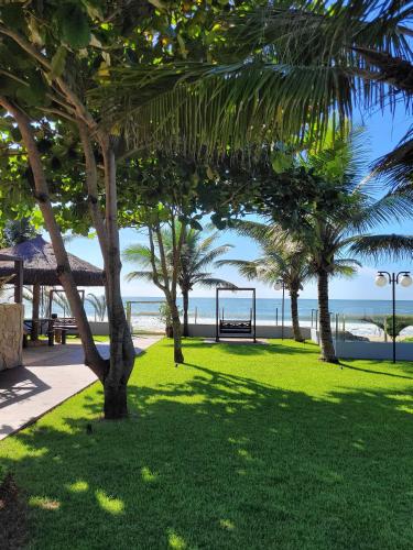 a park with palm trees and a swing at Casa Cancun Hotel Boutique & Eventos in Penha