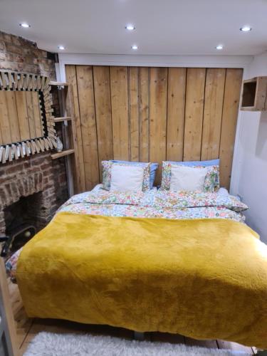a bedroom with a large bed and a fireplace at The Seaside Hideaway St Leonards in Hastings