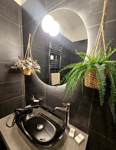 a bathroom with a black sink and a mirror at BARI SOUL old town in Bari
