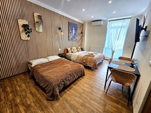 a hotel room with two beds and a table at BARI SOUL old town in Bari