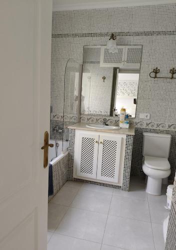 a bathroom with a sink and a toilet and a mirror at Menorca Villa Marbella in Son Parc