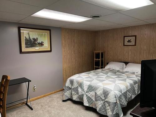 a bedroom with a bed and a table in it at The Fairway Escape in Hayward