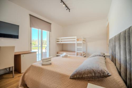 a bedroom with a large bed and a television at Tenuta Bruni - Agriturismo & Pool in Squinzano