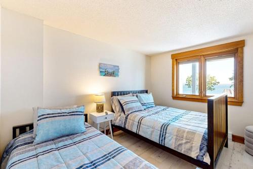a bedroom with two beds and a window at Lakefront At Winnipesaukee in Gilford